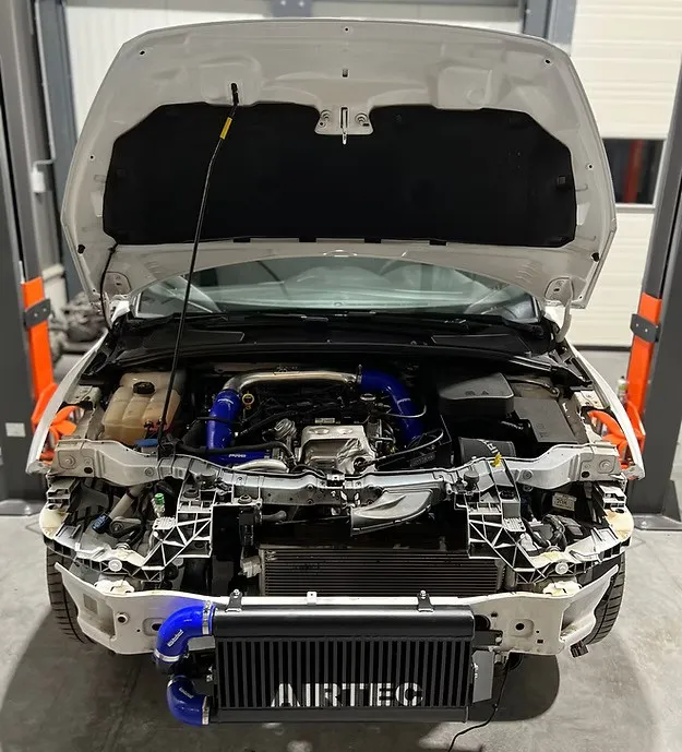 Montage van een Airtec-intercooler in de motorruimte van een Ford Focus